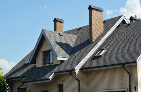 House asphalt shingles rooftop with dormer window, attic skylights, rain gutter, soffits, roof vents